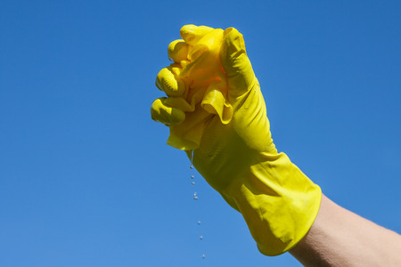 Yelloow wet cleaning cloth in hand.の写真素材