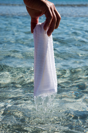 Wet towel in human hand.の写真素材