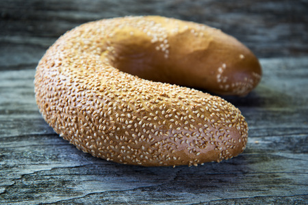 Crescent shape bread roll on wooden background.の写真素材