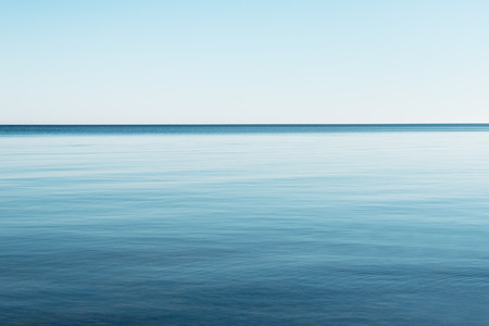 Still Baltic sea and clear blue sky.の写真素材