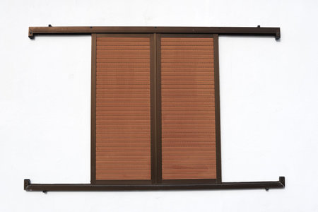 Window closed with wooden shutters.