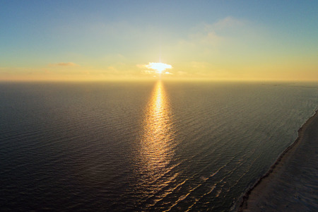 Summer solstice sunset in Baltic sea at latvian coast.の写真素材