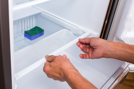 Hands cleaning refrigerator.の写真素材