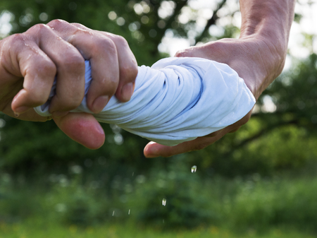 Hands squeeze wet cloth.の写真素材