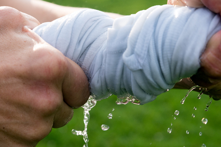 Hands squeeze wet cloth.の写真素材