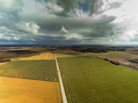 Dark clouds over land in summer afternoon, Tukums area, Latvia.の写真素材