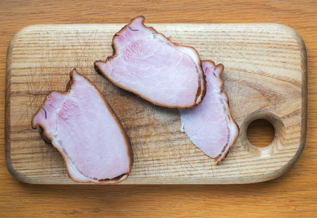 Smoked meat on cutting board.の写真素材