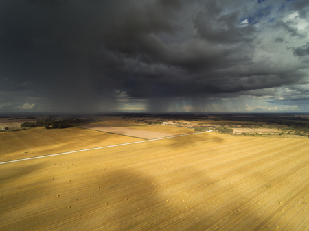 Rain clouds in latvian countryside.の写真素材