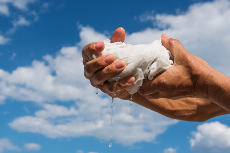 Squeezing of wet cloth.の写真素材