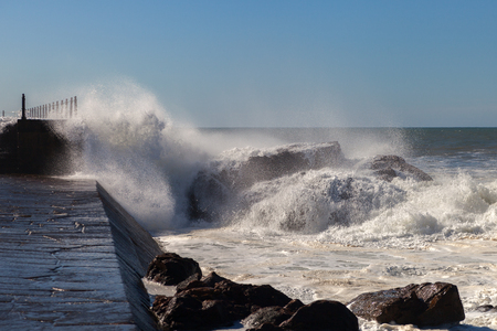 Atlantic wave breaking against mole in Porto, Portugal.の写真素材