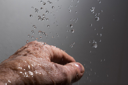Human hand and splahing water.の写真素材