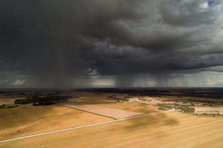 Dark clouds over land , Tukums area, Latvia.の写真素材