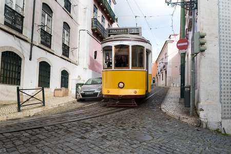Lisbon, Portugal - FEBRUARY 7 , 2016 : typical old style tram passing narrow city street in Lisbon , Portugal.のeditorial素材