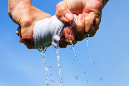 Squeezing of wet cloth.の写真素材