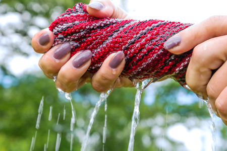 Hands squeeze wet cloth.の写真素材