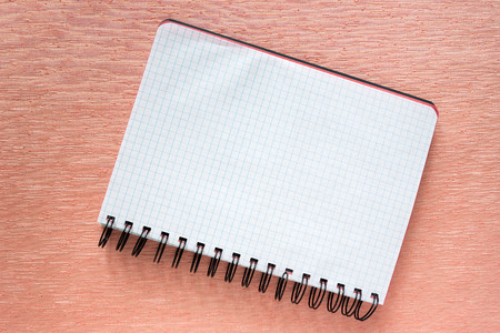 Paper notebookm on pink background.の写真素材