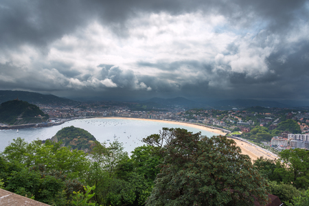 Dark clouds over San Sebastian city, Basque contry, Spain.の写真素材