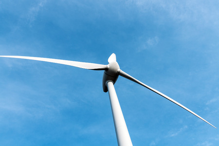 Wind turbine against blue sky.の写真素材