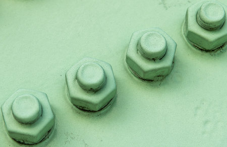Green painted metalic construction with screws.の写真素材