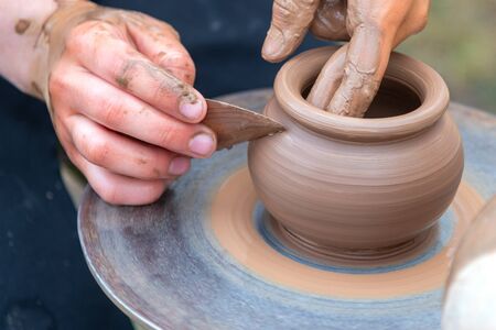 Potter's hands making clay pot.の写真素材