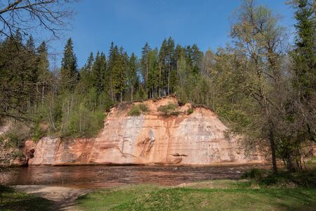 Red sandstone cliff at Gauja river, Latvia.の写真素材