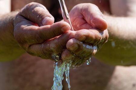 Hand washing in running water.の写真素材