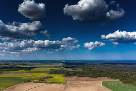 Cloudy sky over countryside landscape.