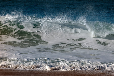 Foamy atlantic wave breaking on coast.