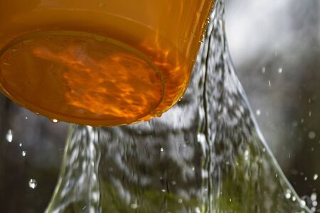 Plastic pail and pouring water.の写真素材