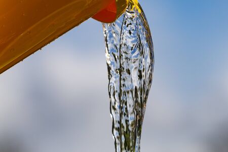 Plastic pail and pouring water.の写真素材