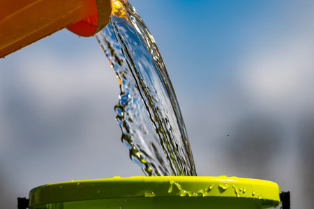 Plastic pail and pouring water.の写真素材