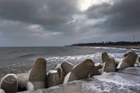 Icy breakwater in winter time.の写真素材