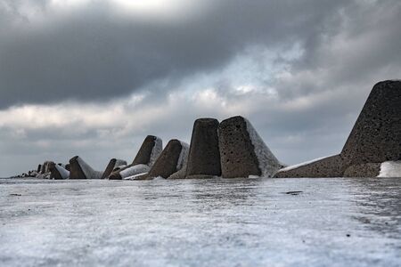 Icy breakwater in winter time.の写真素材