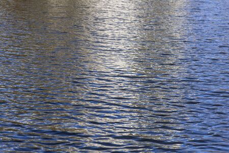 White and blue reflection on water surface.の写真素材