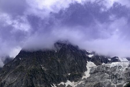 Alpine summits near Mont Blanc in clouds, Italy side.の写真素材