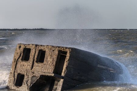 Remains of military fortifications in stormy Baltic sea near Liepaja, Latvia.の写真素材