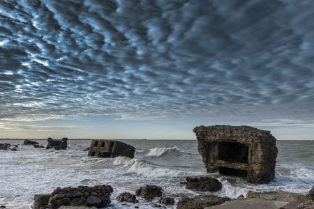 Remains of military fortifications in stormy Baltic sea near Liepaja, Latvia.の写真素材
