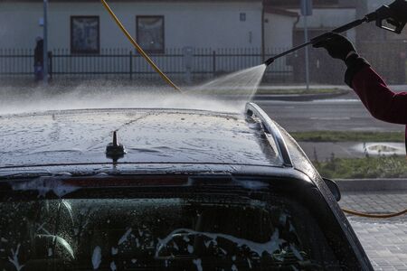 Washing of car by high pressure spray.の写真素材
