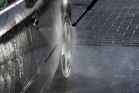Washing of car by high pressure spray.の写真素材