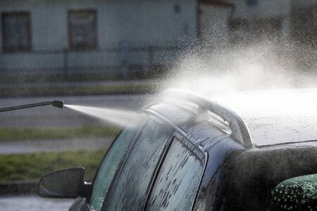 Washing of car by high pressure spray.の写真素材