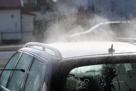 Washing of car by high pressure spray.の写真素材