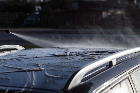 Washing of car by high pressure spray.の写真素材
