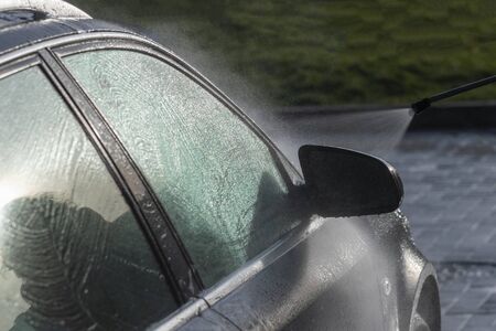 Washing of car by high pressure spray.の写真素材