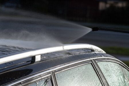Washing of car by high pressure spray.の写真素材