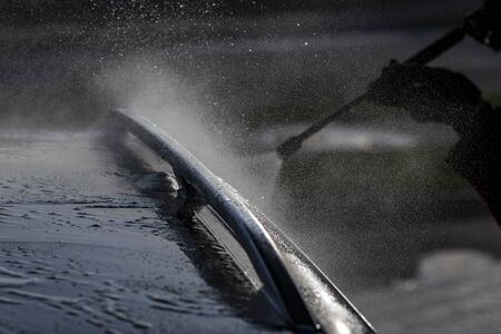 Washing of car by high pressure spray.の写真素材
