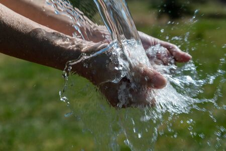 Washing of hands in the outdoors.の写真素材
