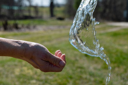 Splahing water on human hands.の写真素材