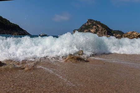 Splashing sea water on Corfu beach, Grecce.の写真素材
