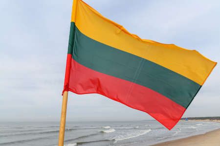 Lithuanian flag in wind at coast of Lithuania.の写真素材