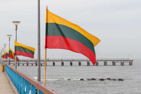 Lithuanian flag in wind at coast of Lithuania.の写真素材